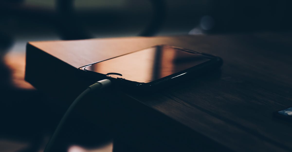 Charging mobile phones in Mongolia - Shallow Focus Photography of Black Iphone 7 on Brown Wooden Table Charging mobile phones in Mongolia - Shallow Focus Photography of Black Iphone 7 on Brown Wooden Table