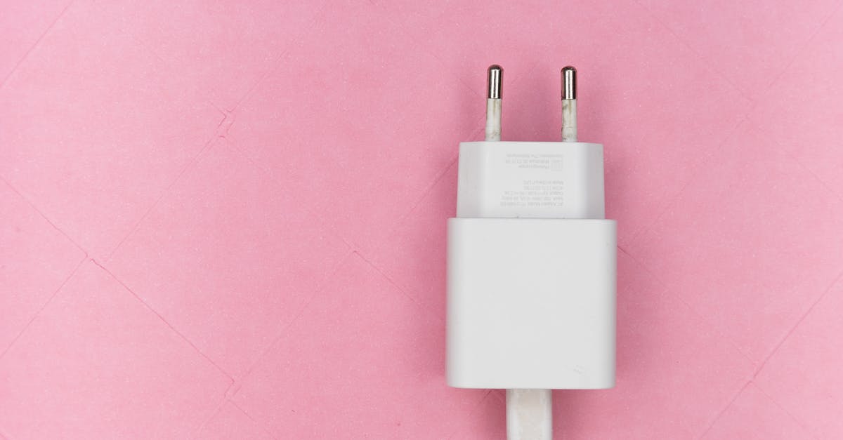 Charging mobile phones in Mongolia - Mobile Adapter on Pink Surface Charging mobile phones in Mongolia - Mobile Adapter on Pink Surface