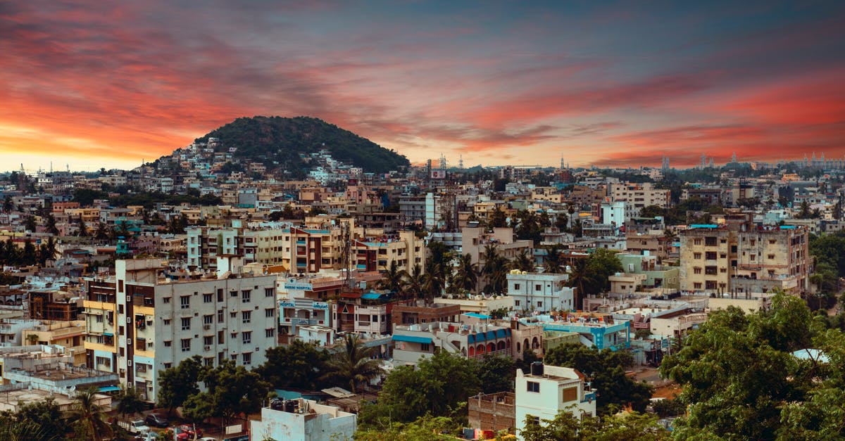 Charter flights to India - City With High Rise Buildings Near Mountain Under Orange and Blue Sky Charter flights to India - City With High Rise Buildings Near Mountain Under Orange and Blue Sky