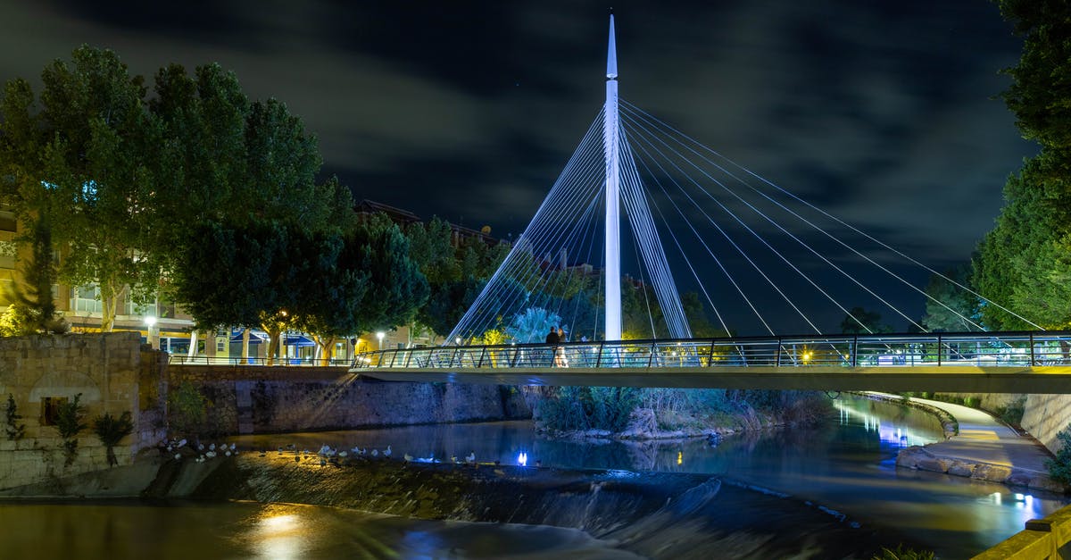 Cheap accommodation in Spain - White Bridge over River during Night Time Cheap accommodation in Spain - White Bridge over River during Night Time