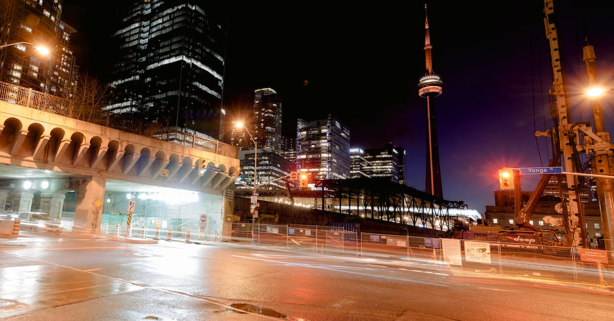 Cheap but comfortable way to get from Kingston, ON, Canada to Toronto? - Cityscape with empty road near bridge and modern multistory buildings and CN tower located on dark street with glowing lights Cheap but comfortable way to get from Kingston, ON, Canada to Toronto? - Cityscape with empty road near bridge and modern multistory buildings and CN tower located on dark street with glowing lights