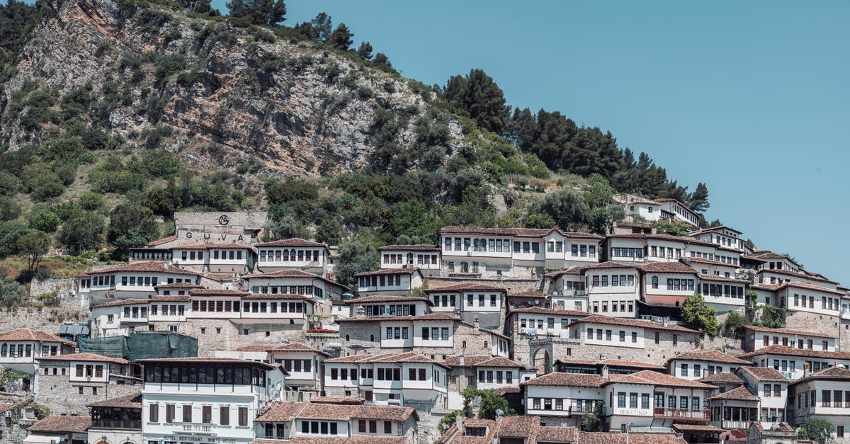 Cheap last-minute flights in Europe - White and Brown Concrete Building Near Green Trees Cheap last-minute flights in Europe - White and Brown Concrete Building Near Green Trees