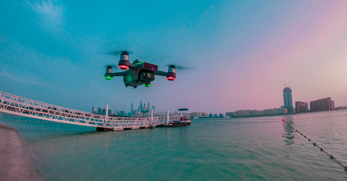 Cheapest flight "from any city" - Modern drone filming video while flying above city river Cheapest flight "from any city" - Modern drone filming video while flying above city river