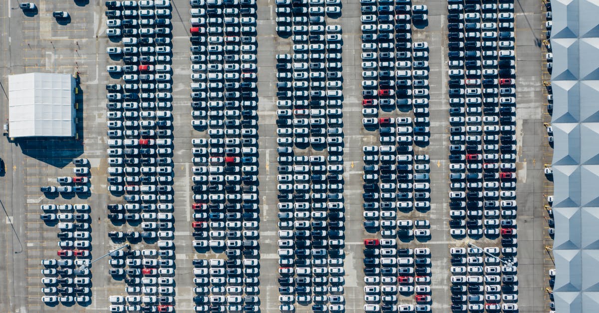 Cheapest transport (other than walking) from ACY to touristy area in Atlantic City - Aerial view of various modern vehicles parked in row on street near modern building on sunny day Cheapest transport (other than walking) from ACY to touristy area in Atlantic City - Aerial view of various modern vehicles parked in row on street near modern building on sunny day