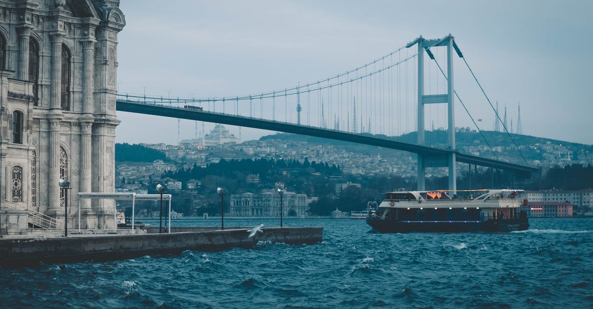 Cheapest transport to go to Istanbul from Van(Turkey) - Cruise boat floating on river near suspension bridge and old mosque Cheapest transport to go to Istanbul from Van(Turkey) - Cruise boat floating on river near suspension bridge and old mosque