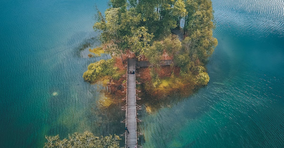 Cheapest way to get from Zurich to Elba Island, Italy? - Wooden bridge leading to small green island in water Cheapest way to get from Zurich to Elba Island, Italy? - Wooden bridge leading to small green island in water