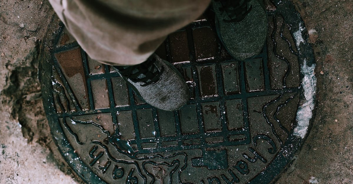 Cheapest way to get HON circle status? - From above anonymous person in boots and pants standing on shabby metal manhole lid on city street Cheapest way to get HON circle status? - From above anonymous person in boots and pants standing on shabby metal manhole lid on city street