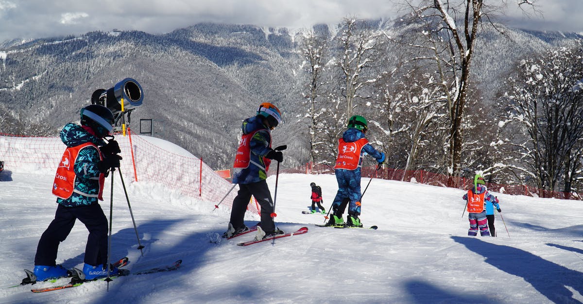 Cheap/free ski passes for children - Children Skiing on the Mountain Slope Covered in Snow