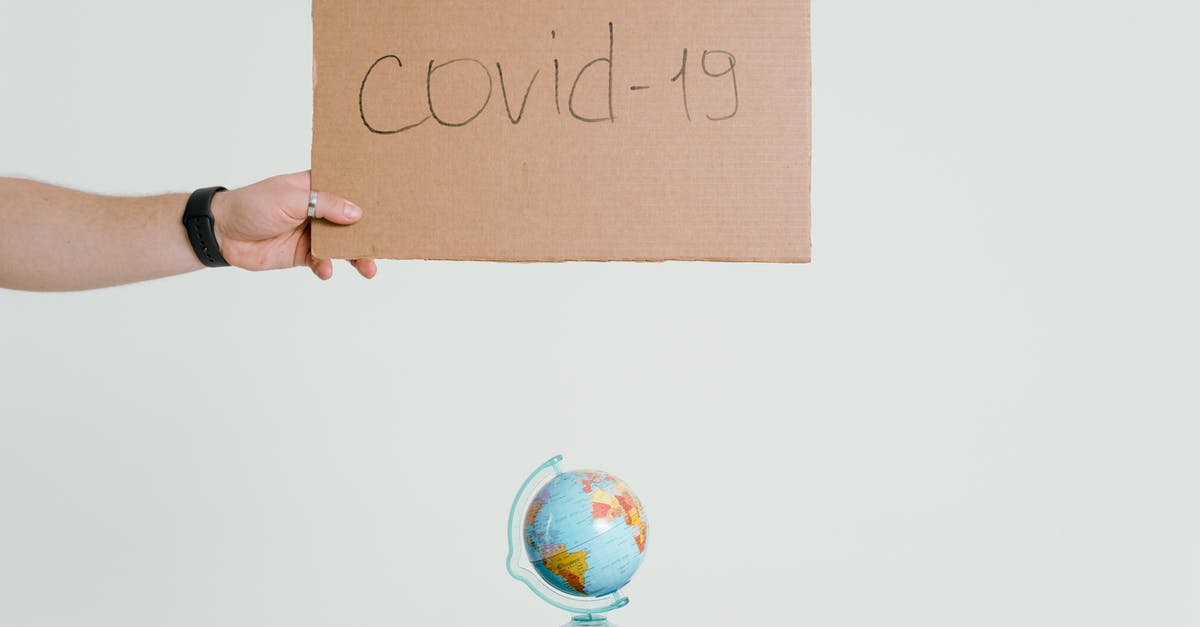 Check-in of hand luggage - A Person Holding Brown Cardboard Check-in of hand luggage - A Person Holding Brown Cardboard