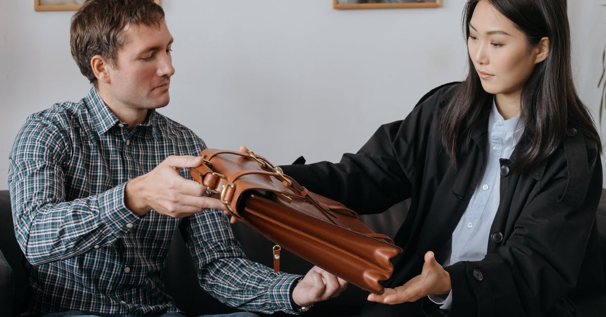 Checking bags through on separate OneWorld bookings? - A Woman Looking a Leather Briefcase Checking bags through on separate OneWorld bookings? - A Woman Looking a Leather Briefcase