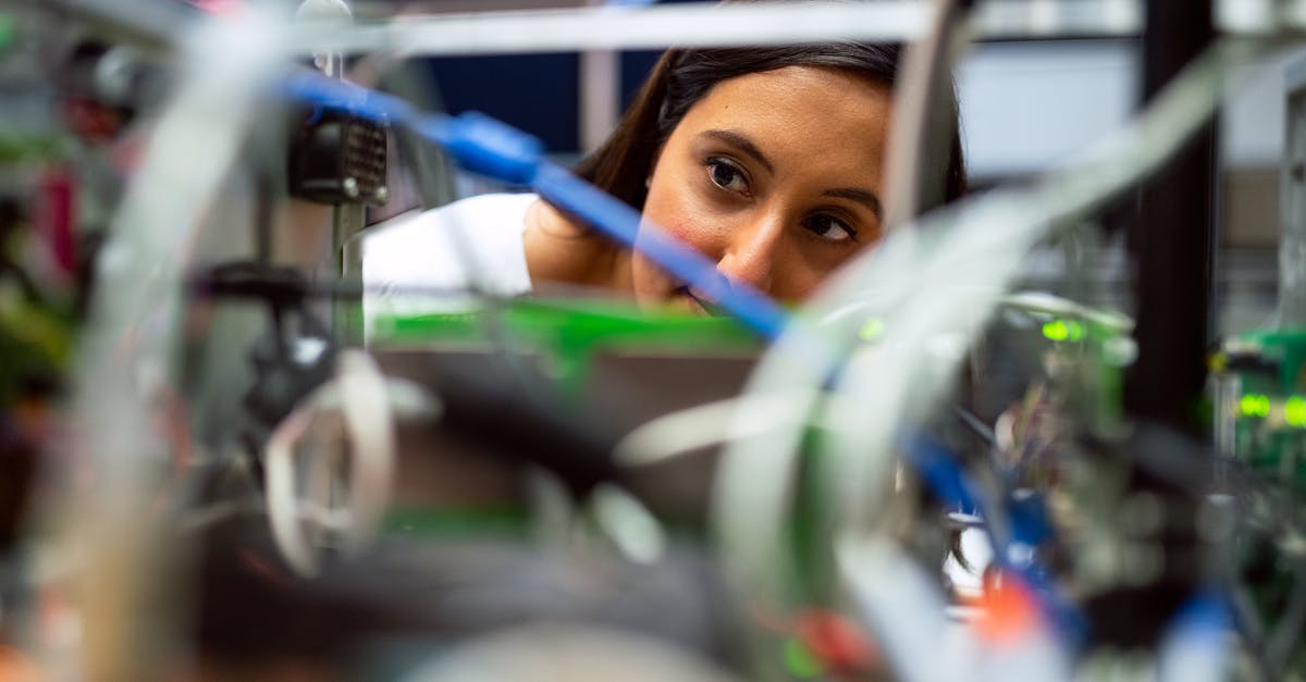 Checking ski equipment on plane - Photo Of Female Engineer Looking Through Wires Checking ski equipment on plane - Photo Of Female Engineer Looking Through Wires