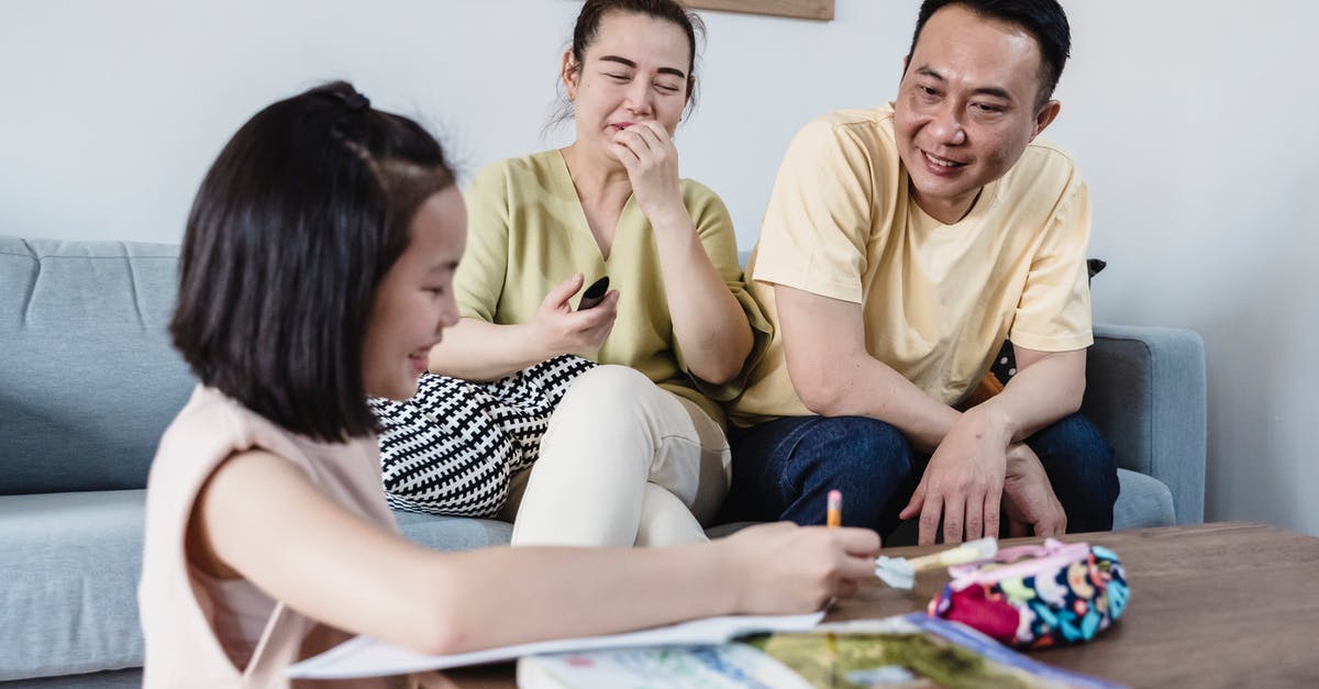 Child entering Canada with both parents - A Girl Showing her Homework to her Parents Child entering Canada with both parents - A Girl Showing her Homework to her Parents