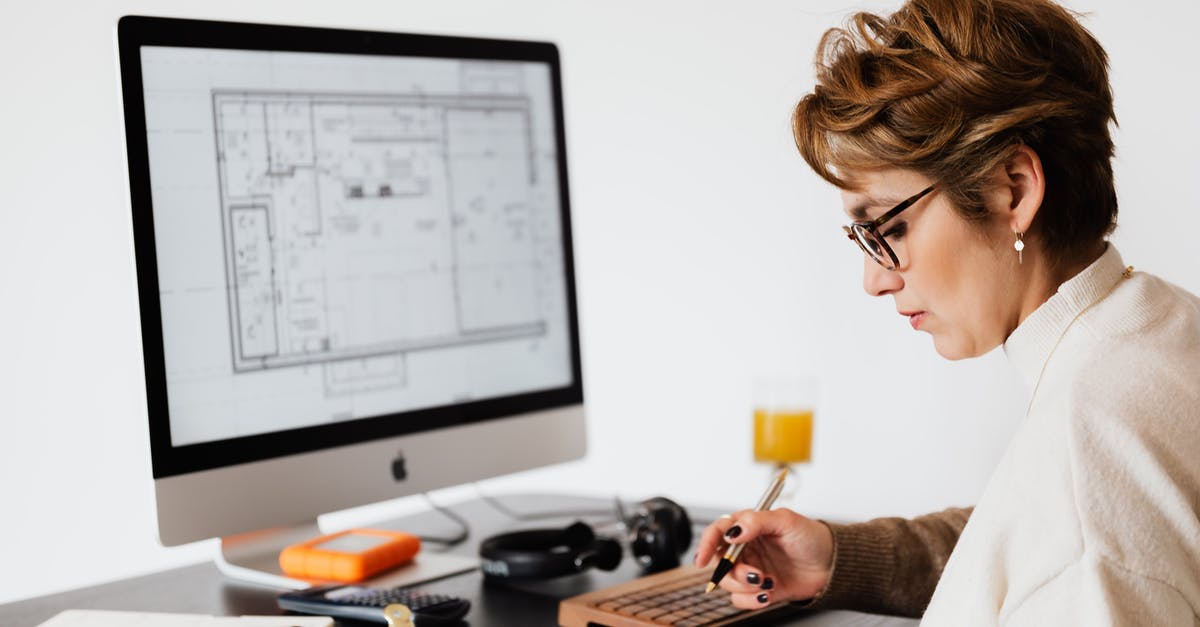 Chinese F visa for doing research for short term (2 months) - Focused woman editing paper documents during work at desk with computer Chinese F visa for doing research for short term (2 months) - Focused woman editing paper documents during work at desk with computer