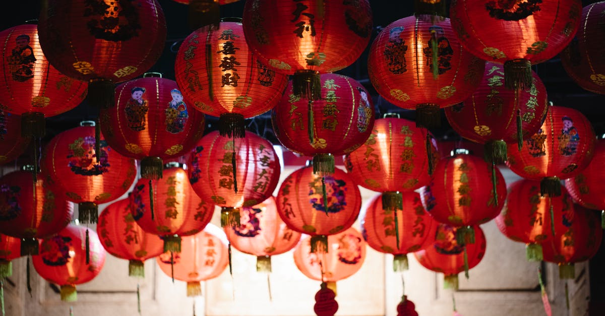 Chinese visa limited to 30 days (new immigration law)? - From below of many red rice paper lanterns with golden hieroglyphs hanging on street during celebration of Chinese Spring Festival Chinese visa limited to 30 days (new immigration law)? - From below of many red rice paper lanterns with golden hieroglyphs hanging on street during celebration of Chinese Spring Festival