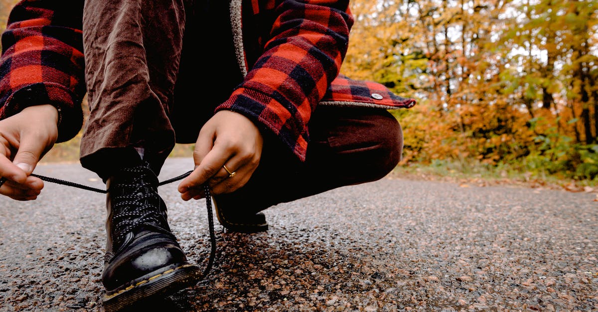 Choosing hiking shoes [closed] - Person Tying Her Shoelaces