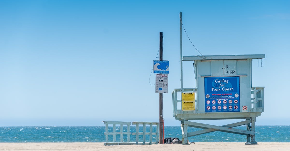 Circular signs with blue edges - Blue Wooden Lifeguard Tower on Beach Circular signs with blue edges - Blue Wooden Lifeguard Tower on Beach
