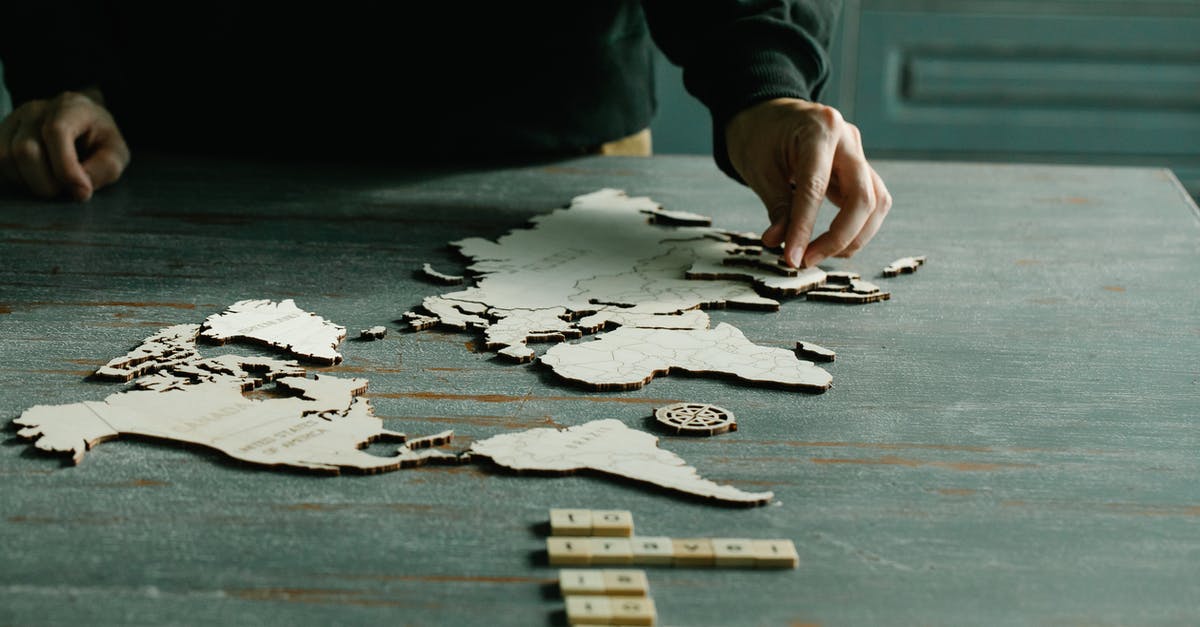 Clean/bright clothing in third world countries - Person Completing a World Puzzle Clean/bright clothing in third world countries - Person Completing a World Puzzle