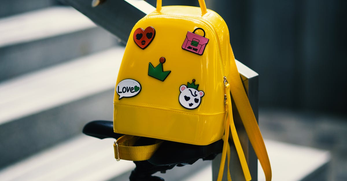 Clear backpack bags on Icelandair - Yellow Backpack With Five Assorted Stickers on Grey Metal Stairway Rail Clear backpack bags on Icelandair - Yellow Backpack With Five Assorted Stickers on Grey Metal Stairway Rail