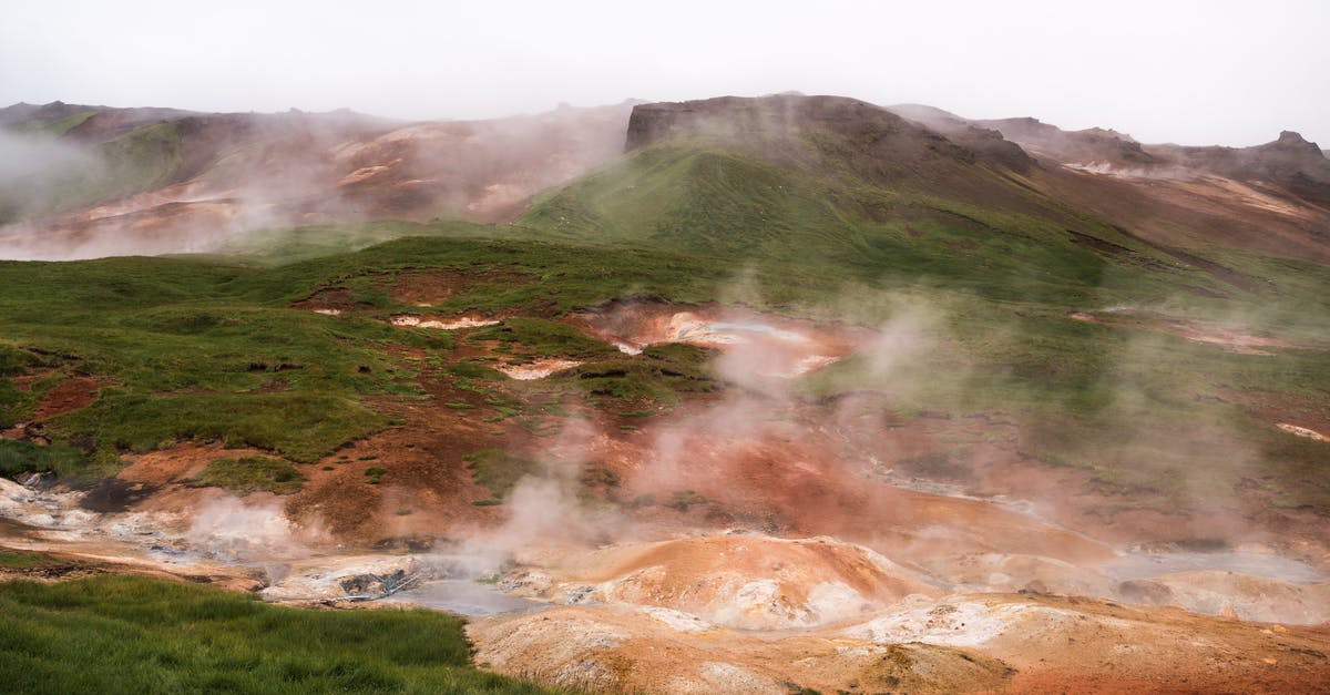 Closest place to Addis Ababa where you can see wildlife - Hilled country with geysers blowing steam off among grass area against volcanic mountains in cloudy day Closest place to Addis Ababa where you can see wildlife - Hilled country with geysers blowing steam off among grass area against volcanic mountains in cloudy day