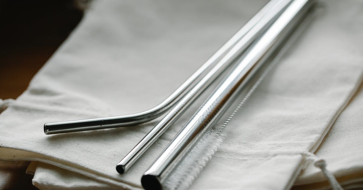 Collecting bag at MSP - Collection of stainless steel straight and bent straws placed on reusable bags on table Collecting bag at MSP - Collection of stainless steel straight and bent straws placed on reusable bags on table