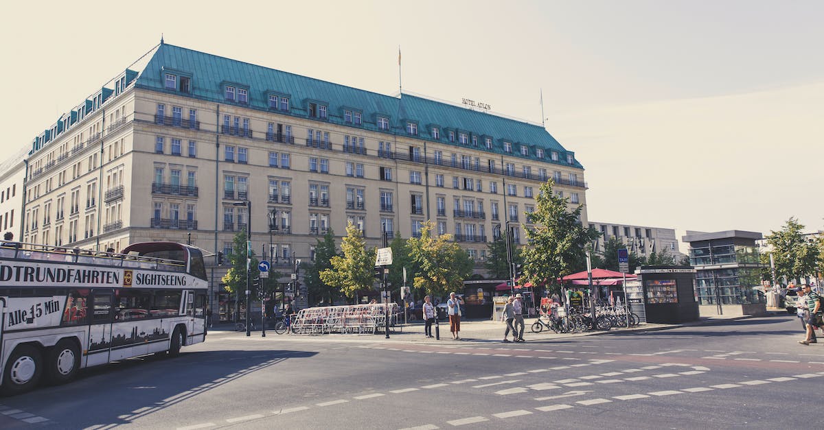 Comparing travel costs in Europe: rail vs bus - People Walking on Sidewalk Near Building Comparing travel costs in Europe: rail vs bus - People Walking on Sidewalk Near Building