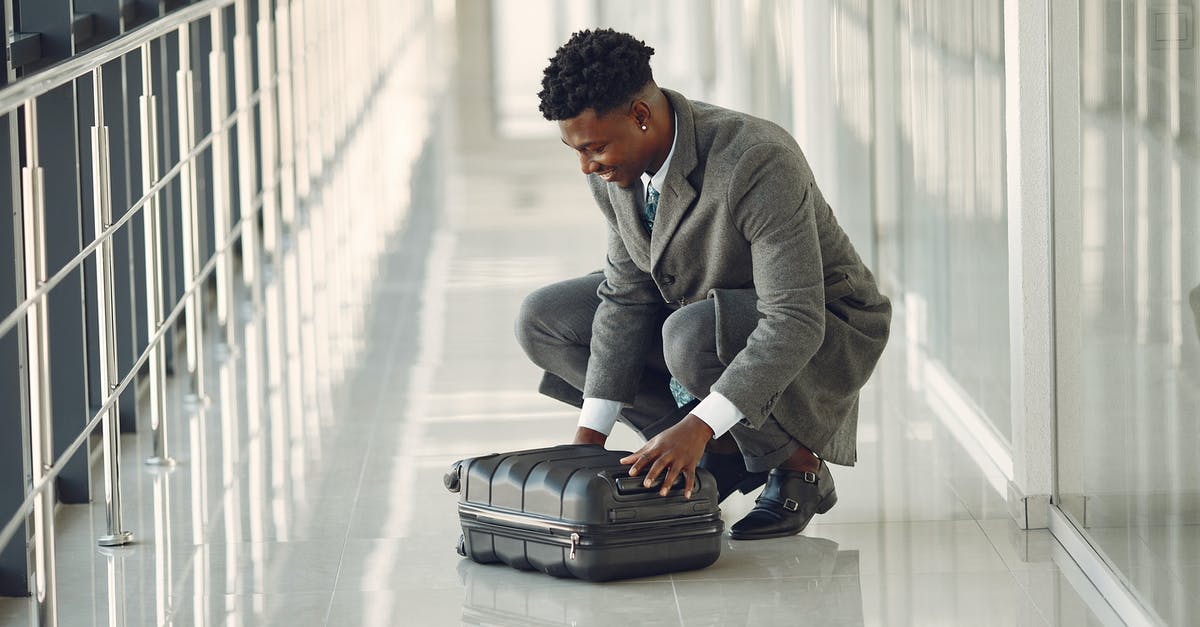Compensation for denied boarding due to baggage delay - Elegant businessman with suitcase standing in airport hallway Compensation for denied boarding due to baggage delay - Elegant businessman with suitcase standing in airport hallway