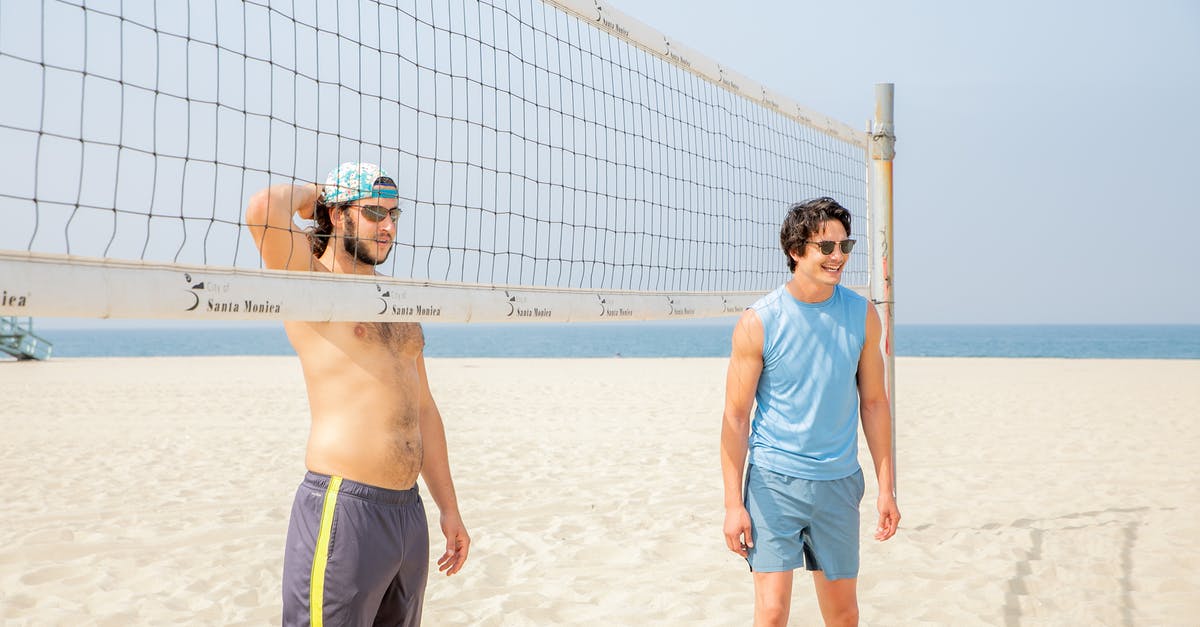 Confused over 6-month Canadian eTA vs 3-month US ESTA - Two Men Standing by Volleyball Net on Beach