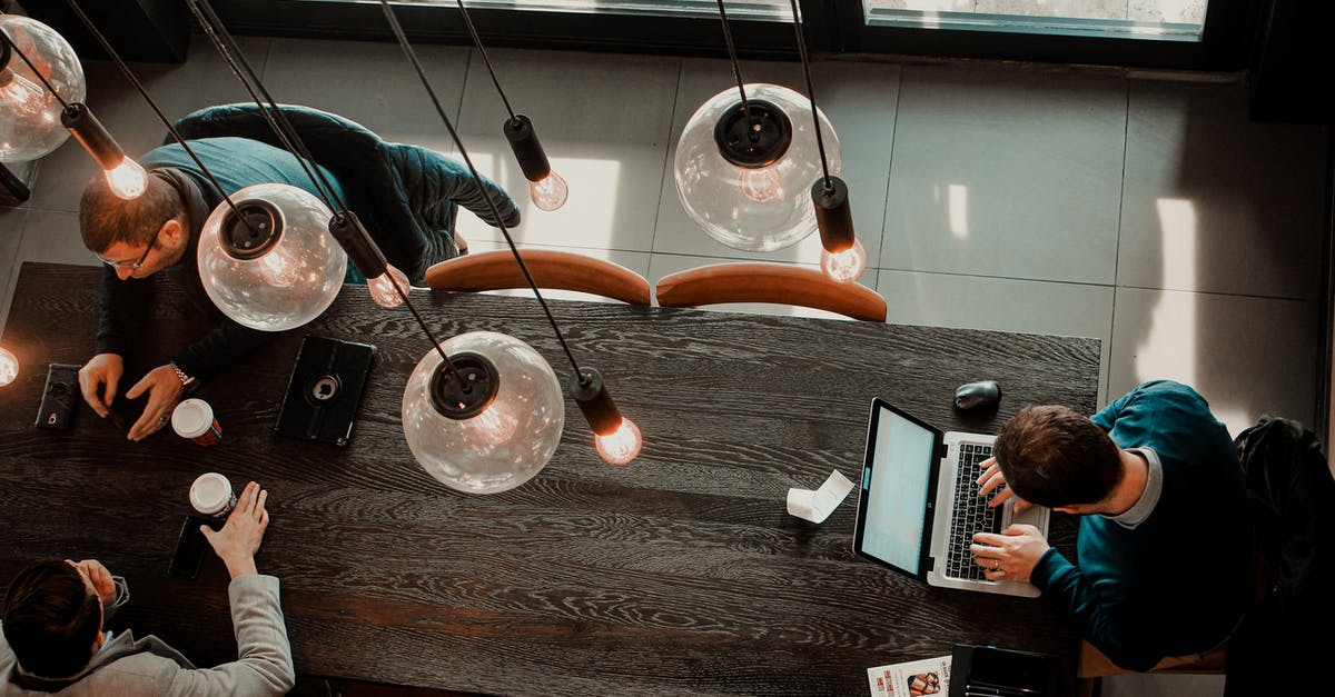 Connecting separate Airlines in Thailand - Modern men in creative workspace with coffee and gadgets Connecting separate Airlines in Thailand - Modern men in creative workspace with coffee and gadgets