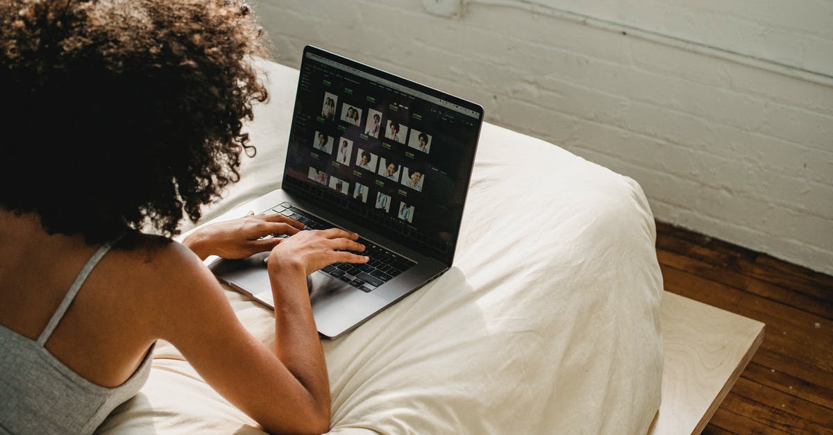 Connection time at Nassau from/to Europe to/from a Bahamasair domestic flight - Black woman working on laptop in bedroom Connection time at Nassau from/to Europe to/from a Bahamasair domestic flight - Black woman working on laptop in bedroom