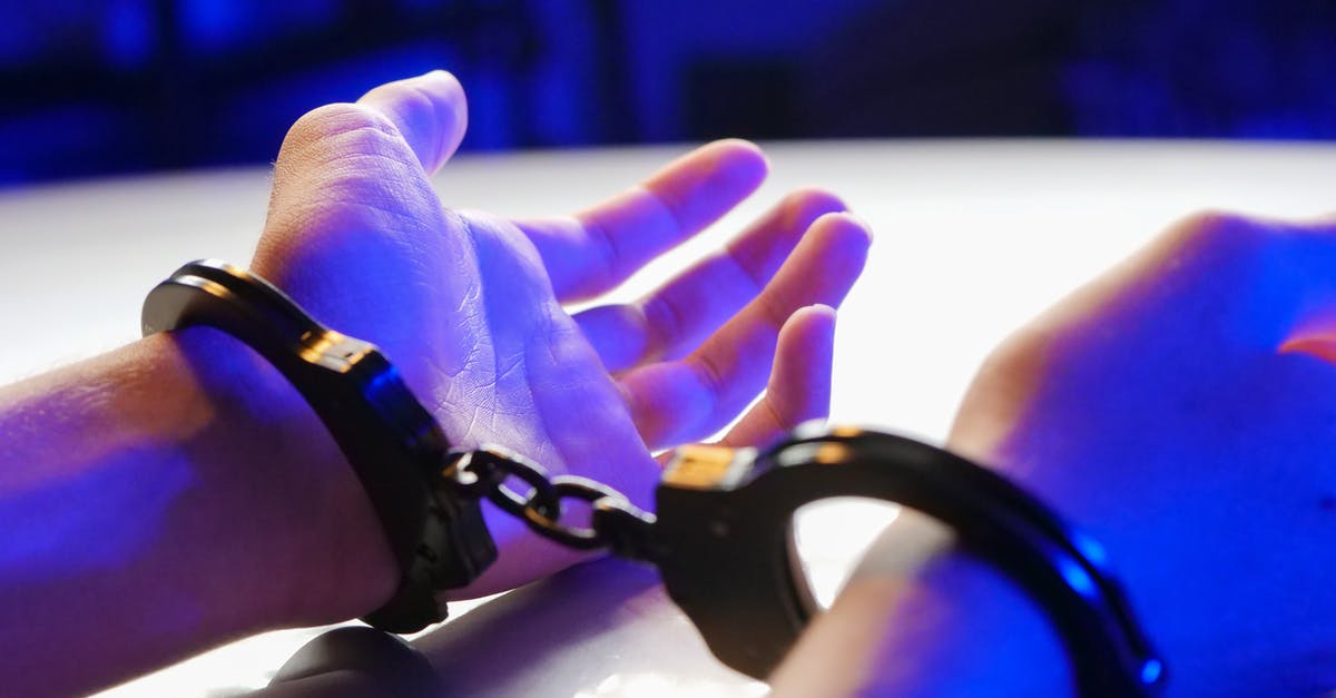 Consequences of being arrested by mistake in the USA - Person Wearing Black Leather Bracelet Consequences of being arrested by mistake in the USA - Person Wearing Black Leather Bracelet