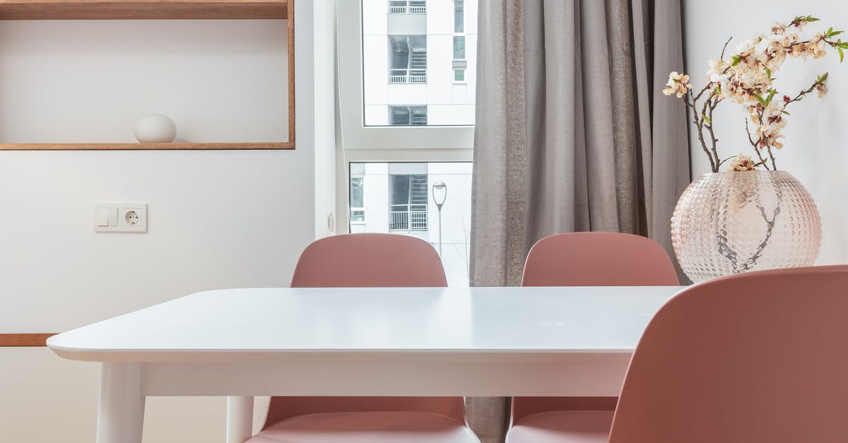 Considerations for very fragile and expensive (> $100,000) items in carry-on luggage - White dining table with chairs in interior of contemporary room with shelves and window with curtains Considerations for very fragile and expensive (> $100,000) items in carry-on luggage - White dining table with chairs in interior of contemporary room with shelves and window with curtains