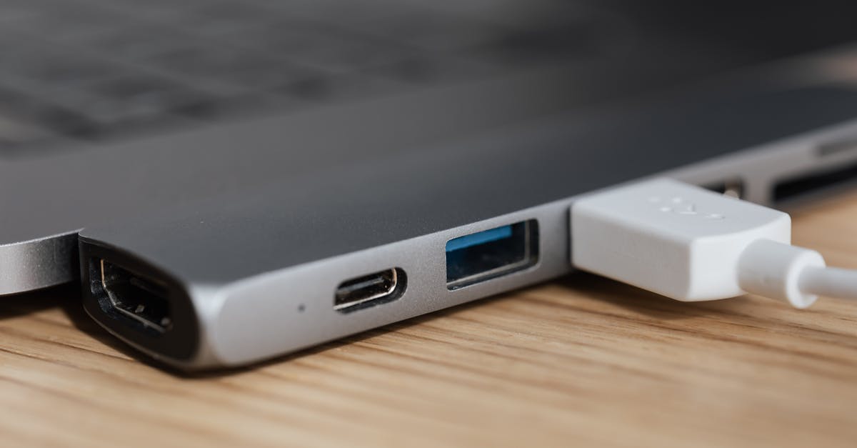 Converter vs Adapter - USB type c multiport adapter with plugged white cable connected to modern laptop Converter vs Adapter - USB type c multiport adapter with plugged white cable connected to modern laptop