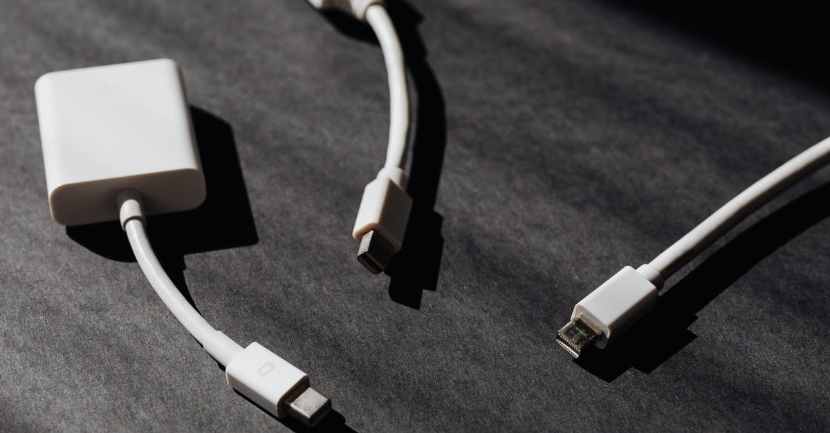 Converter vs Adapter - Set of modern port adapters on black surface Converter vs Adapter - Set of modern port adapters on black surface