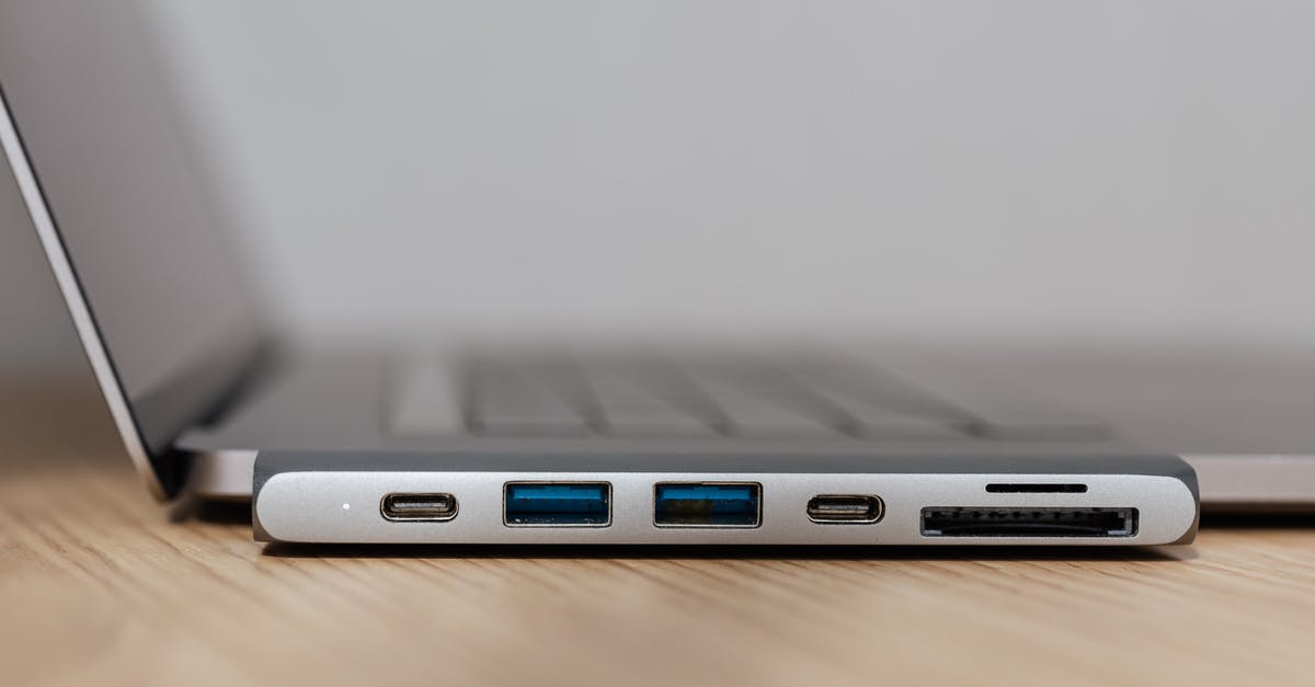 Converter vs Adapter - Space grey type c USB hub with multiple different ports connected to laptop Converter vs Adapter - Space grey type c USB hub with multiple different ports connected to laptop