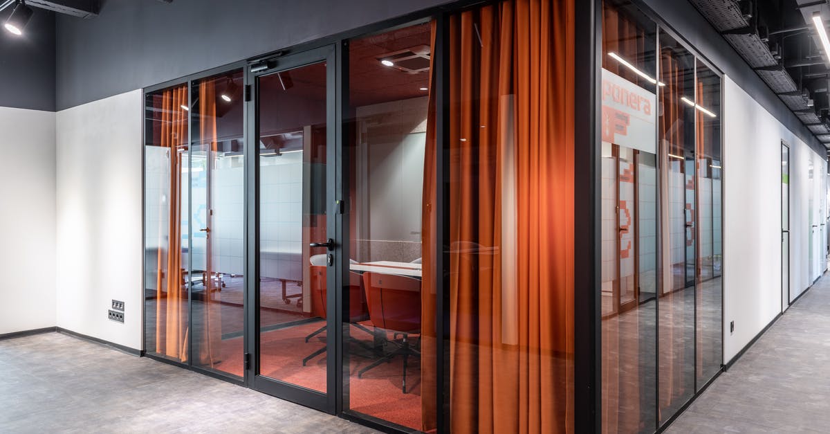 Corridor seats on the TGV — why? Are seat reservations not always mandatory? - Hall of spacious contemporary business center with glass walls of modern office with colorful armchairs at table and red curtain