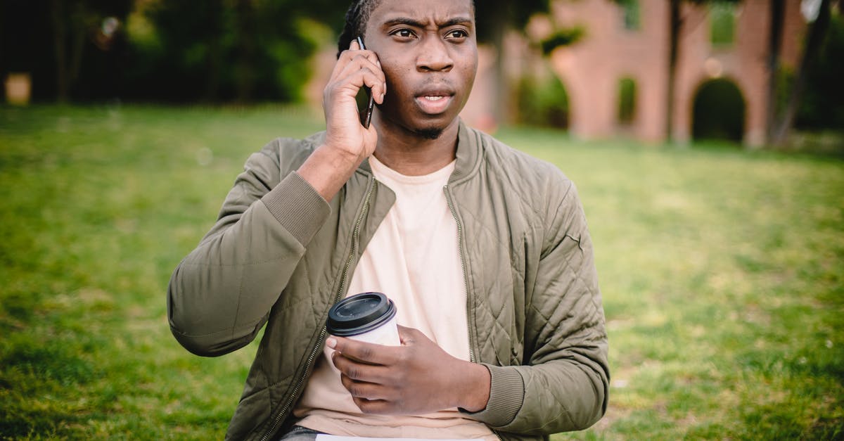 Could I have approached South African Embassy without going through VFSGlobal for faster visa processing and news updates? - Young African American male in casual clothes with cup of coffee to go in hand talking on mobile with expression of displeasure and misunderstanding on face while sitting in park Could I have approached South African Embassy without going through VFSGlobal for faster visa processing and news updates? - Young African American male in casual clothes with cup of coffee to go in hand talking on mobile with expression of displeasure and misunderstanding on face while sitting in park