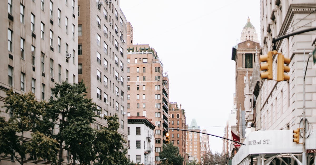 Could you actually get in trouble if you don't stick to the transport and accommodation stated in your visa application? - Modern city street with concrete buildings