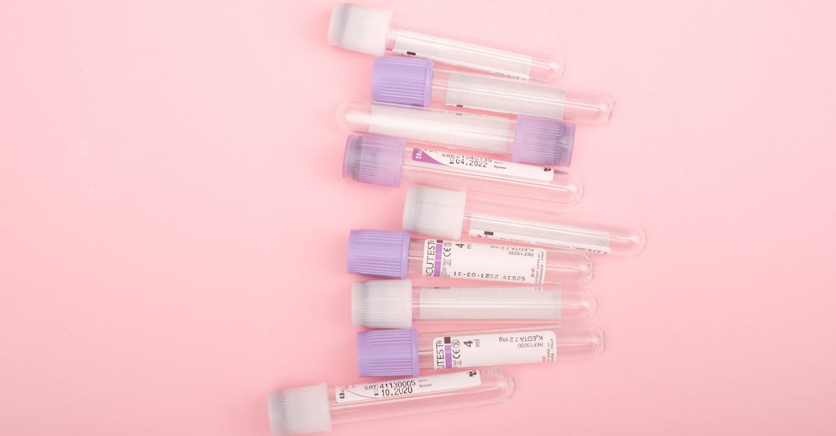 Covid test requirements for teens/children, when crossing by land into the US from Mexico - Top view of transparent glass test tubes with stickers placed on pink background Covid test requirements for teens/children, when crossing by land into the US from Mexico - Top view of transparent glass test tubes with stickers placed on pink background