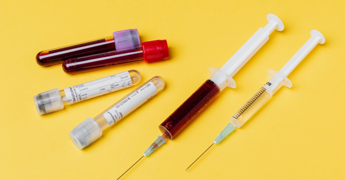 CPH airport (Copenhagen) covid test center? - From above of medical syringe with medication near injector with blood sample arranged with filled clinical test tubes placed on yellow background CPH airport (Copenhagen) covid test center? - From above of medical syringe with medication near injector with blood sample arranged with filled clinical test tubes placed on yellow background