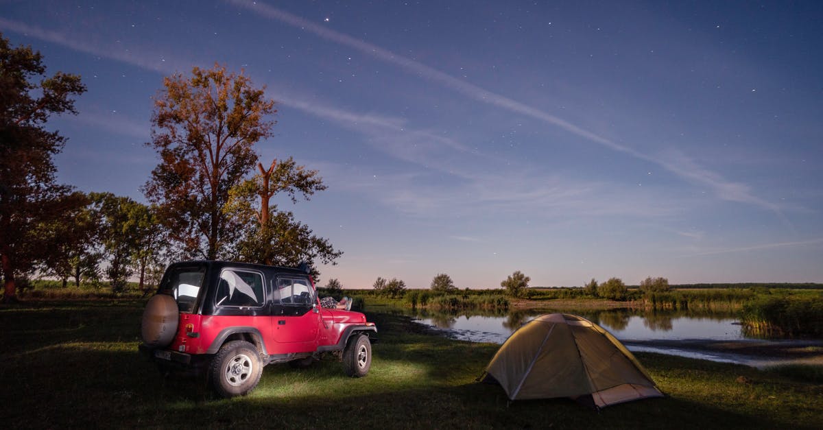 Crater Lake Oregon - can you sleep in your car at night? - Red Jeep Parked Beside Green Trees Crater Lake Oregon - can you sleep in your car at night? - Red Jeep Parked Beside Green Trees