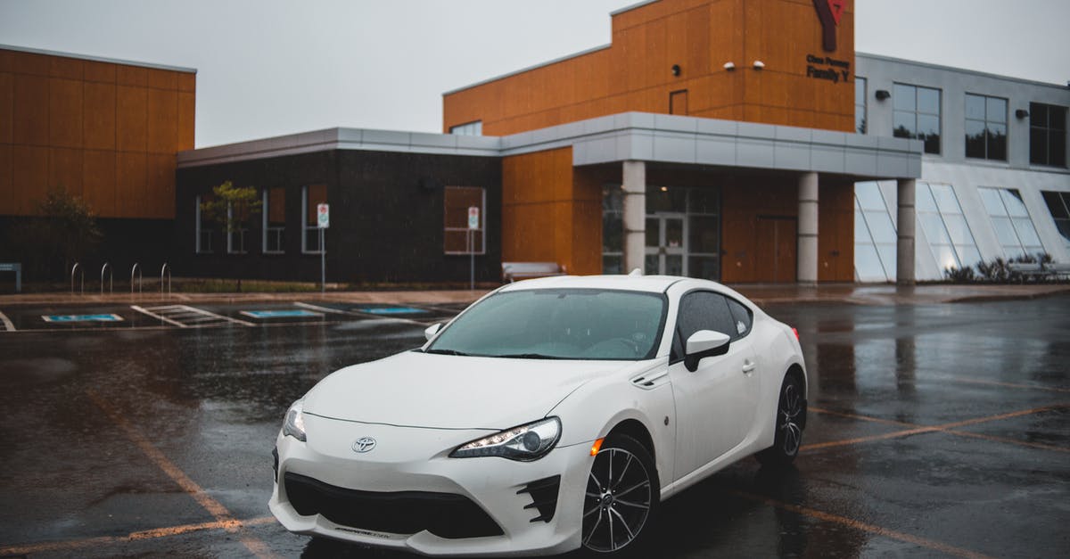 Creative ways to get from NY City to New Haven CT not using cars/vans [closed] - From above of contemporary sport automobile on asphalt roadway near house exterior under sky in city