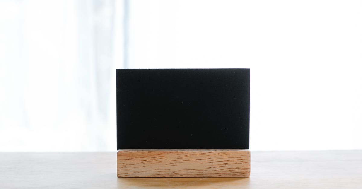Credit card name mismatch because of long name - Empty black name card on wooden holder placed on desk in modern workplace Credit card name mismatch because of long name - Empty black name card on wooden holder placed on desk in modern workplace