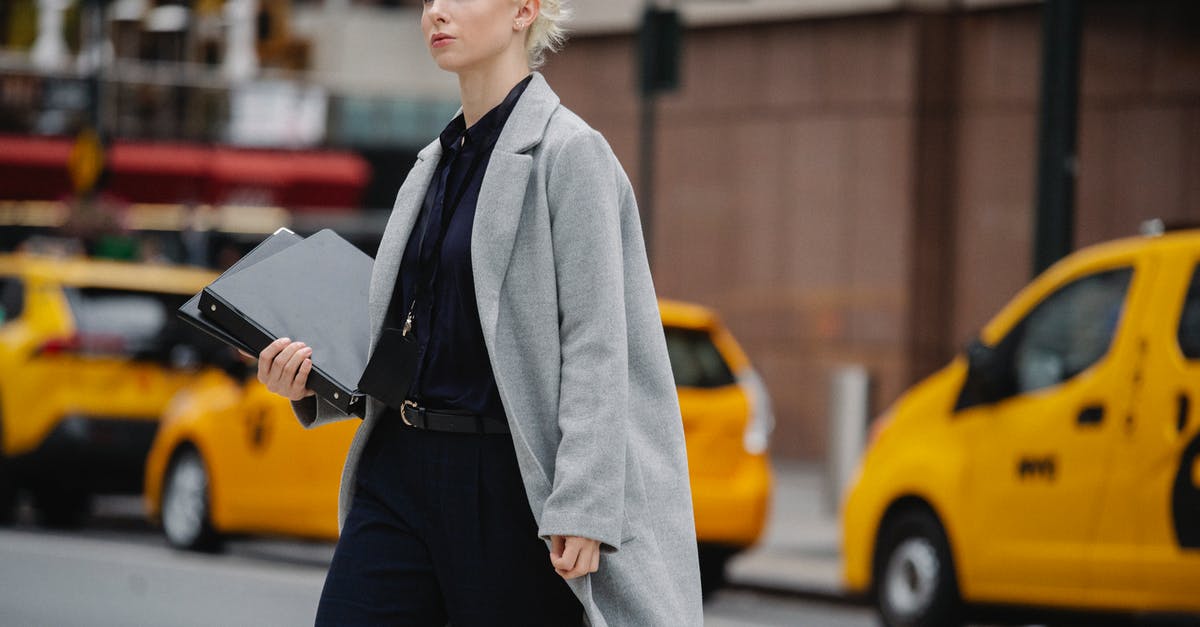 Cross Border Work Visa Requirement? - Serious businesswoman with folders crossing busy road Cross Border Work Visa Requirement? - Serious businesswoman with folders crossing busy road