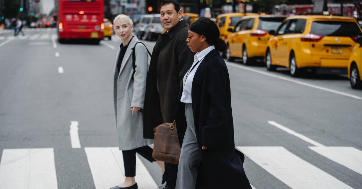 Cross Border Work Visa Requirement? - Positive multiethnic businesspeople crossing road in downtown Cross Border Work Visa Requirement? - Positive multiethnic businesspeople crossing road in downtown