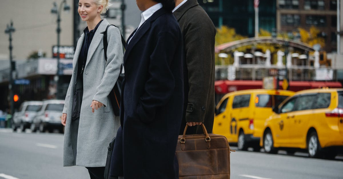 Cross Border Work Visa Requirement? - Cheerful diverse colleagues crossing road in downtown Cross Border Work Visa Requirement? - Cheerful diverse colleagues crossing road in downtown
