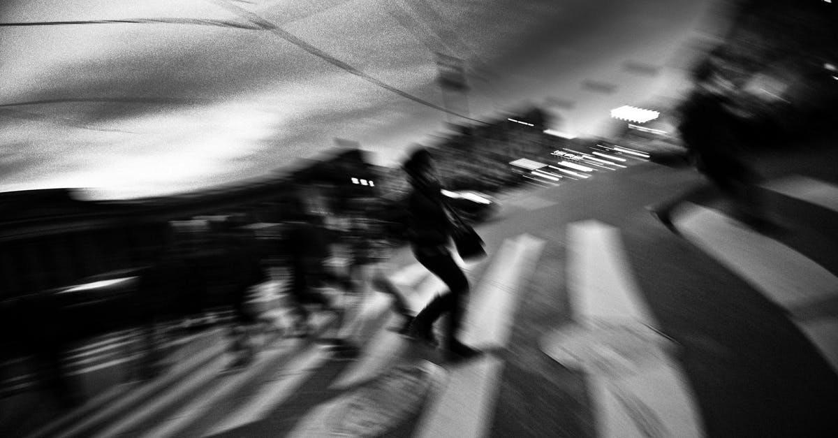 Cross mark on a visa stamp - Bahamas - Black and white of anonymous pedestrians crossing asphalt road on zebra in city Cross mark on a visa stamp - Bahamas - Black and white of anonymous pedestrians crossing asphalt road on zebra in city