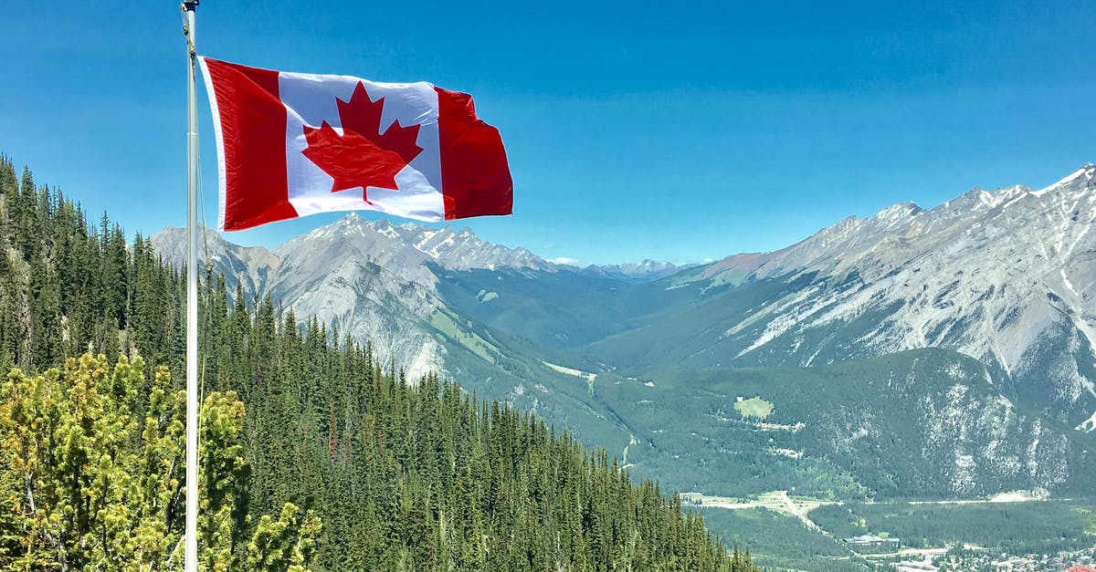 Cross US-Canada border at Glacier NP - Canada Flag With Mountain Range View Cross US-Canada border at Glacier NP - Canada Flag With Mountain Range View