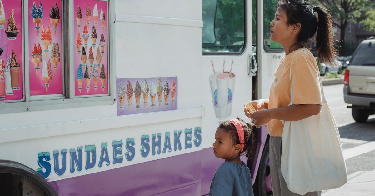 Crossing a border with an infant of a different citizenship - Asian mother with little adorable daughter choosing ice cream Crossing a border with an infant of a different citizenship - Asian mother with little adorable daughter choosing ice cream