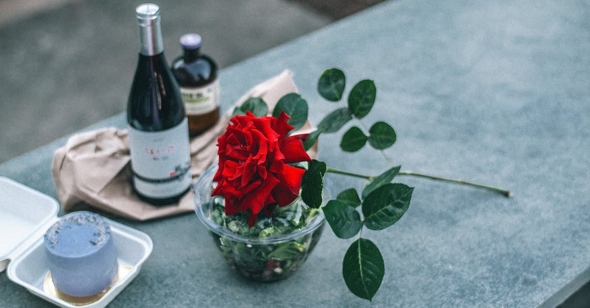 Crossing border from India to Myanmar - Composition of red rose placed on parapet near champagne bottle Crossing border from India to Myanmar - Composition of red rose placed on parapet near champagne bottle