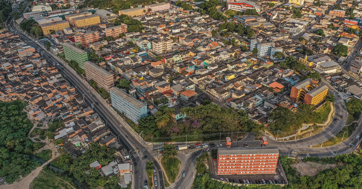 Crossing the Amazon, route 319 - Drone view of residential houses located amidst lush green trees growing on street with crossroad in modern district of city Crossing the Amazon, route 319 - Drone view of residential houses located amidst lush green trees growing on street with crossroad in modern district of city